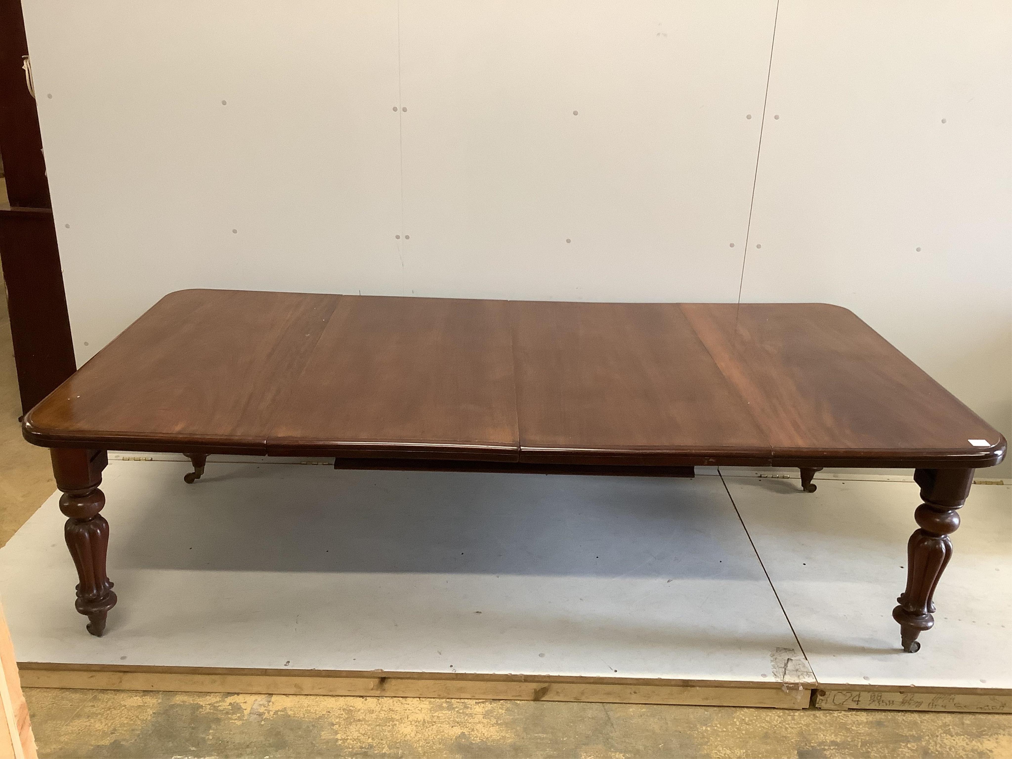 A Victorian mahogany extending dining table, width 238cm extended, two spare leaves, depth 120cm, height 68cm together with a set of six reproduction Regency style dining chairs (two with arms). Condition - fair to good